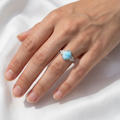 Oval-Larimar-Stone-Bezel-Ring-on-Hand-with-Sparkly-CZ-Shoulders